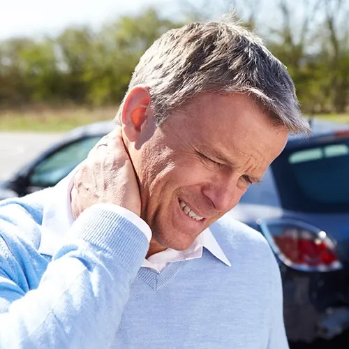 Man holding his neck in pain.