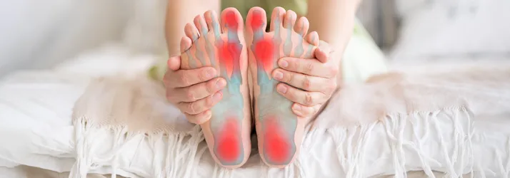 Chiropractic Portland OR Foot Pain A person holding their feet in pain.