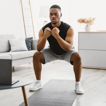 A man balancing in his living room.